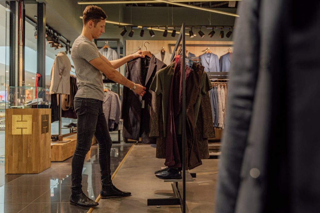 pexels-photo-5264914 A Man Looking at a Suit Jacket in a Clothing Store